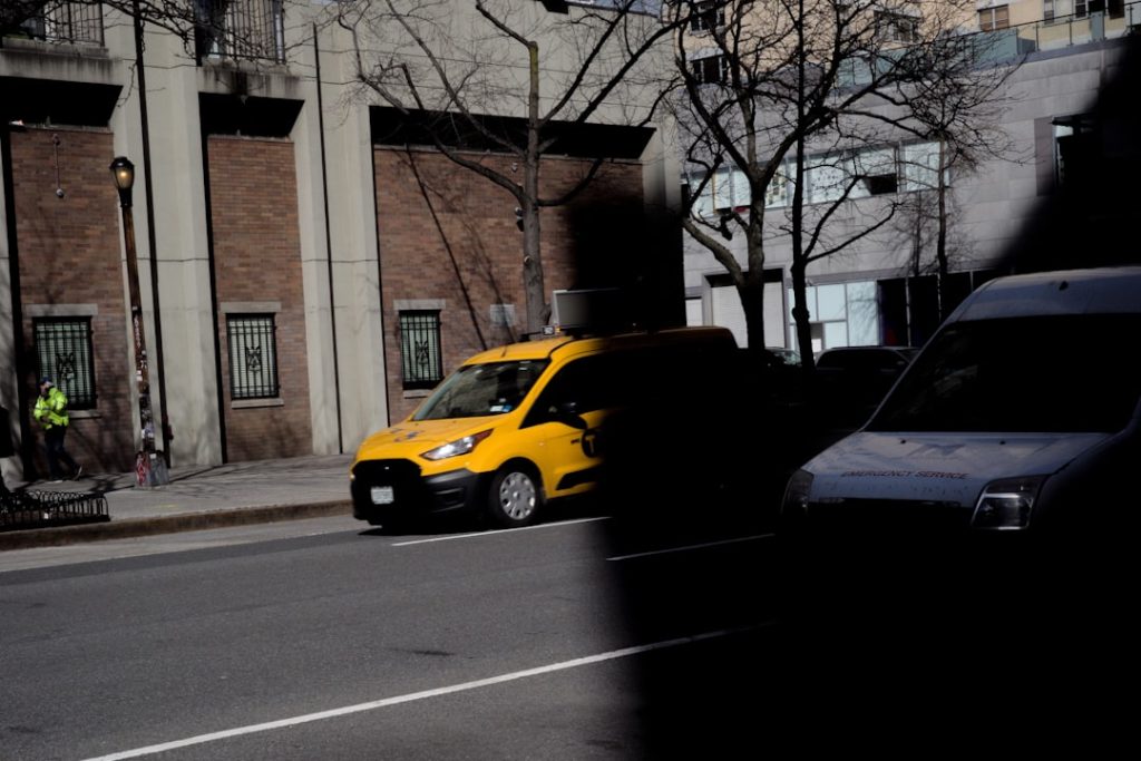 a-yellow-van-is-parked-on-the-side-of-the-road-bae-xvtdte