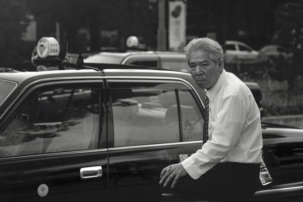 Japanese taxi driver on his last day of work. He is retiring after 40 years of service.