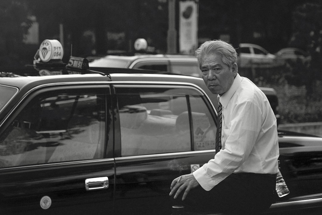 Japanese taxi driver on his last day of work. He is retiring after 40 years of service.